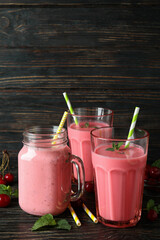 Cherry smoothie and ingredients on rustic wooden table