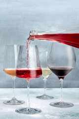 Rose wine pour from a bottle into a glass. Wine tasting with copy space