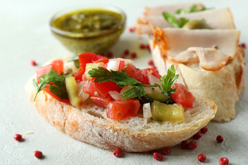 Delicious bruschetta snacks on white textured background