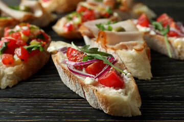 Delicious italian snacks bruschetta on wooden background