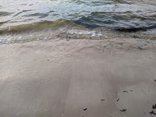 tide on the sandy shore in the evening.