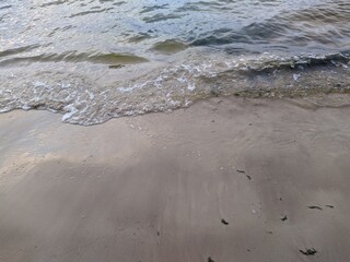 tide on the sandy shore in the evening.