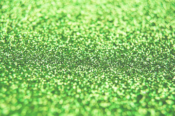 Fototapeta premium Abstract shiny blurred green background. Textured glittering backdrop for your projects. Copy space