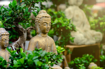 Close up of  Buddha statue in bonsai trees garden - Powered by Adobe