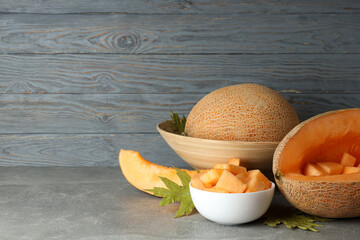 Concept of fresh food with melon on gray textured table
