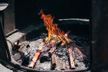 Scented sticks are burned in a special stump, a religious ritual