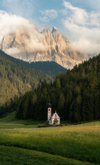 Beautiful Church of St. John (Chiesetta di San Giovanni) located in the Dolomites in Italy, south of the Alps in the Val di Funes, isolated chapel in the middle of the mountains, high resolution pano.