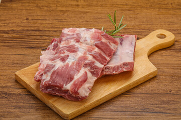 Raw pork ribs served rosemary