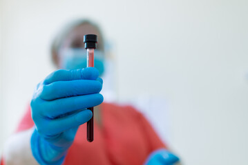 Nurse holding a blood test tube in a laboratory clinic.Closeup.Copy space.