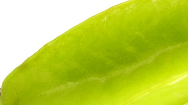 4K Organic star fruit carambola or star apple ( starfruit ) close-up rotates on a white background