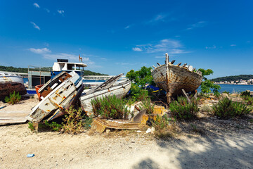 broken boats on the shore, Losinj town, Croatia.
