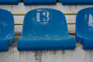 Empty stadium seats with number 13 . Baker's dozen concept . sports superstitions