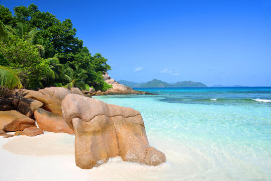 Coast with big granite boulders of the island La Digue, Anse Severe beach, Indian ocean, Seychelles. Tropical destination.