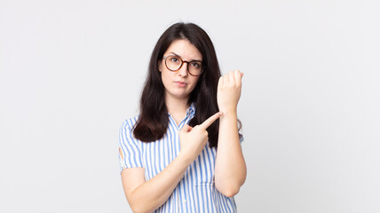 pretty woman looking impatient and angry, pointing at watch, asking for punctuality, wants to be on...