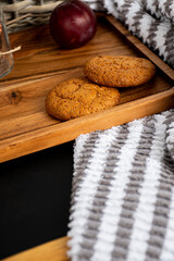 homemade cookies on a wooden table and white and gray scarf 