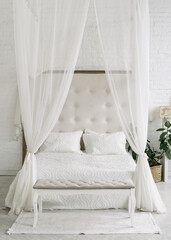 Fototapeta na wymiar White bedroom interior, closeup at canopy bed.