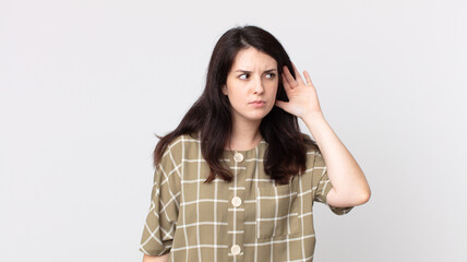 pretty woman looking serious and curious, listening, trying to hear a secret conversation or...