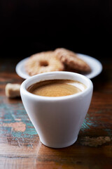 Cup of coffee on rustic wooden background. Close up. 