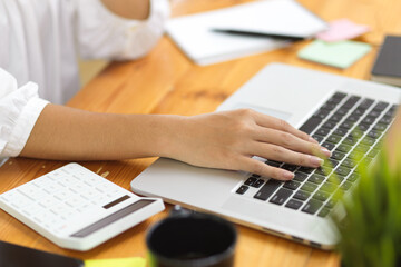 Fototapeta na wymiar Close up, female college student typing on laptop keyboard