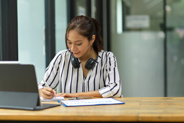 College student woman doing homework, taking lecture, reading online books