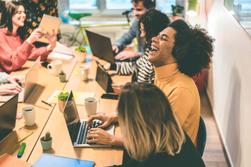 Young multiracial people having fun working inside coworking office - Focus african man face