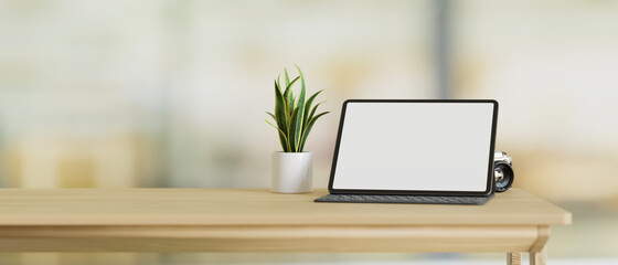 Tablet computer blank screen mockup stand on wood table with copy space, blurred background