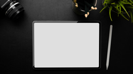 Business workspace, digital tablet blank screen mockup on black background