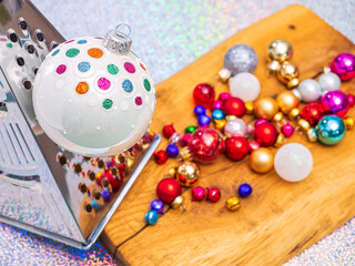 Cooking or prepare Christmas, conceptual photo. Christmas bauble on grater for vegetables grind on wooden cutting board