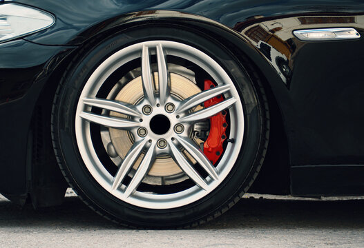 gray rims, tires and brake discs of the sports car © oktay