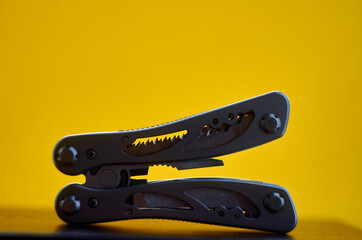 Photo of multitool on yellow background