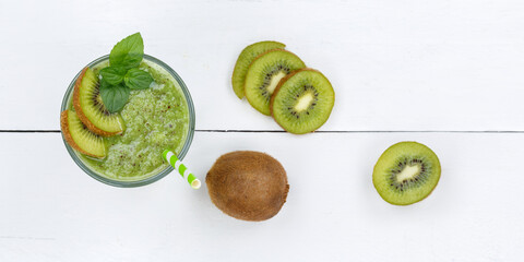 Green smoothie fruit juice kiwi drink in a glass from above panorama