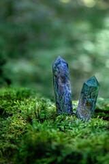 Gemstones crystals in mysterious forest, natural green background. Magic quartz minerals for healing Crystal Ritual, Witchcraft, spiritual esoteric practice. Reiki life balance concept