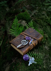 magic witch book, gemstones minerals, wiccan amulet with pentagram on forest natural background....