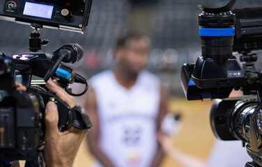 basketball player giving an interview focus on professional cameras - obrazy, fototapety, plakaty