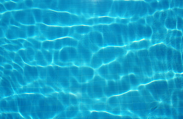 Fototapeta na wymiar Swimming pool water surface in the sunlight