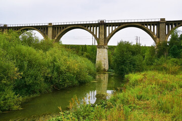 Fototapeta na wymiar Old railway viaduct across the river