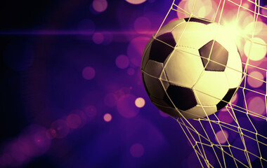 soccer ball in goal with spotlight
