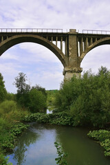 Fototapeta na wymiar Old railway viaduct across the river