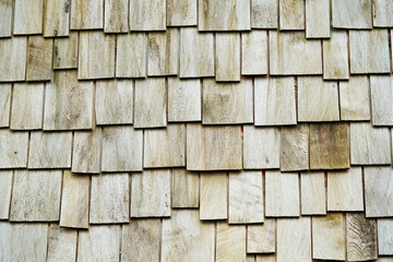 Wood paneling of a wall with wooden shingles. Background with wood texture