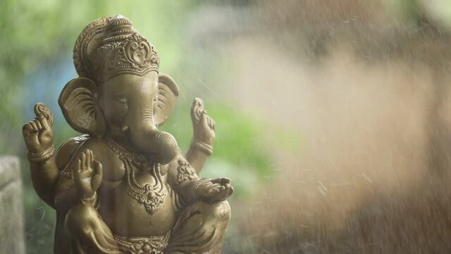 Water splash on lord ganesha sculpture. celebrate lord ganesha festival. 