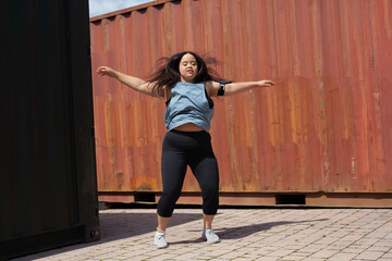 Young biracial woman with Down Syndrome in active wear and wearable tech working out
