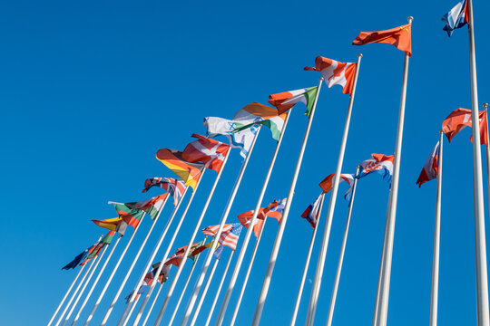 Different flags fluttering on flagpoles