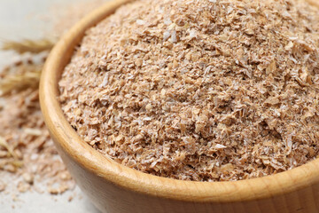 Dry wheat bran in bowl, closeup view
