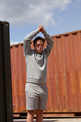 Young man with Down Syndrome in active wear stretching his arms