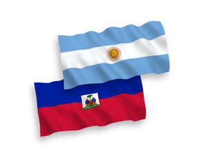 National vector fabric wave flags of Republic of Haiti and Argentina isolated on white background. 1 to 2 proportion.