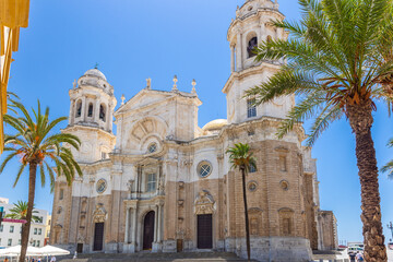 Fototapeta na wymiar Façade of beautiful Cathedral of Cadiz, View of main entrance. Roman Catholic church in Cádiz, southern Spain. Architect Vicente Acero. Neoclassical style. 