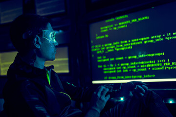 Cyber hacker breaks into databases to obtain information using a computer.