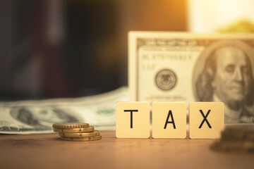 Prepare for TAX reduction concept. TAX word and USA bills on background. Business planning photo