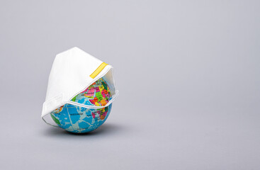 A mock-up of a globe under a respirator. Pandemic. COVID-19.