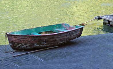 an old wooden boat on a riverbank
